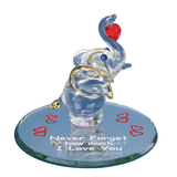 Handcrafted glass elephant holding a red crystal heart on a beveled mirror base with loving message