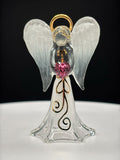 White Angelique glass angel figurine holding rose-colored crystal heart