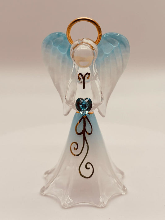 Handcrafted glass angel holding a blue heart-shaped crystal on beveled mirror base with gold and crystal accents