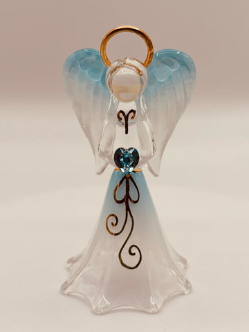 Handcrafted glass angel holding a blue heart-shaped crystal on beveled mirror base with gold and crystal accents