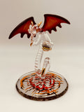Handcrafted glass dragon with red wings holding a crystal ball on beveled mirror base with crystal and gold accents