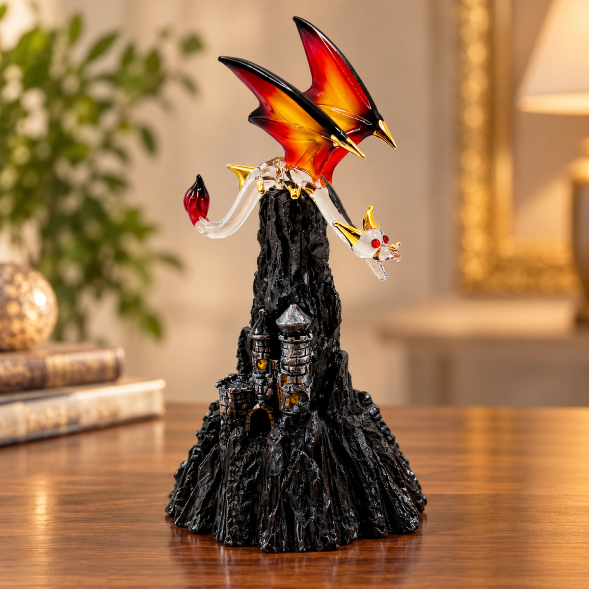 Handcrafted glass dragon figurine with red and orange wings on black mountain base with castle towers