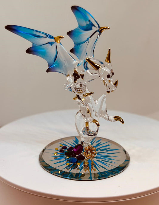 Handcrafted Jewel Keeper Dragon glass figurine with blue wings holding a gem on a beveled mirror base