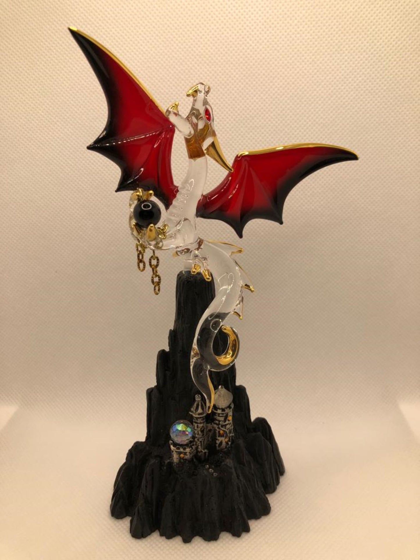 Handcrafted glass dragon perched on mountain fantasy décor