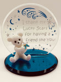 Handcrafted frosted glass bear holding a silver crystal star in front of a sentiment plate reading “I thank my lucky stars for having a friend like you” on a blue mirror base