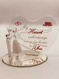 Handcrafted glass couple figurine with man holding a rose on beveled mirror base and heart-shaped back plate with romantic message