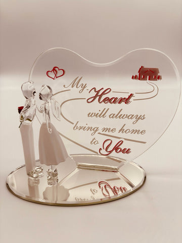 Handcrafted glass couple figurine with man holding a rose on beveled mirror base and heart-shaped back plate with romantic message