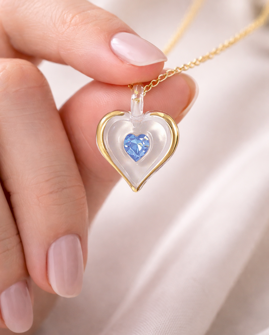 December birthstone heart necklace with light blue crystal pendant on 18 inch gold plated chain