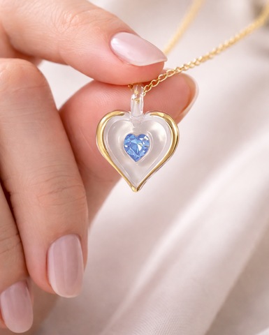 December birthstone heart necklace with light blue crystal pendant on 18 inch gold plated chain