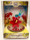 Handcrafted glass hummingbird figurine with red lily and crystal accents in display box