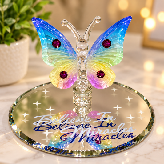 Handcrafted rainbow-colored glass butterfly figurine with crystal accents on a beveled glass mirror embossed with “Believe in Miracles”