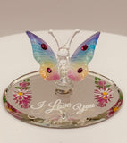 Handcrafted glass butterfly figurine with rainbow coloring on floral mirror base engraved with I Love You