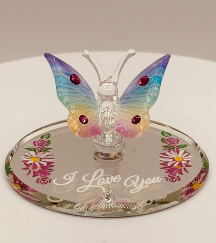 Handcrafted glass butterfly figurine with rainbow coloring on floral mirror base engraved with I Love You