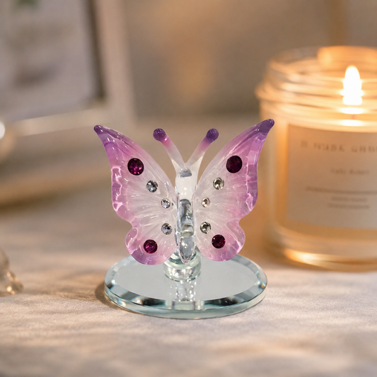 Handcrafted pink glass butterfly figurine with Genuine Crystals displayed on a beveled glass mirror base.