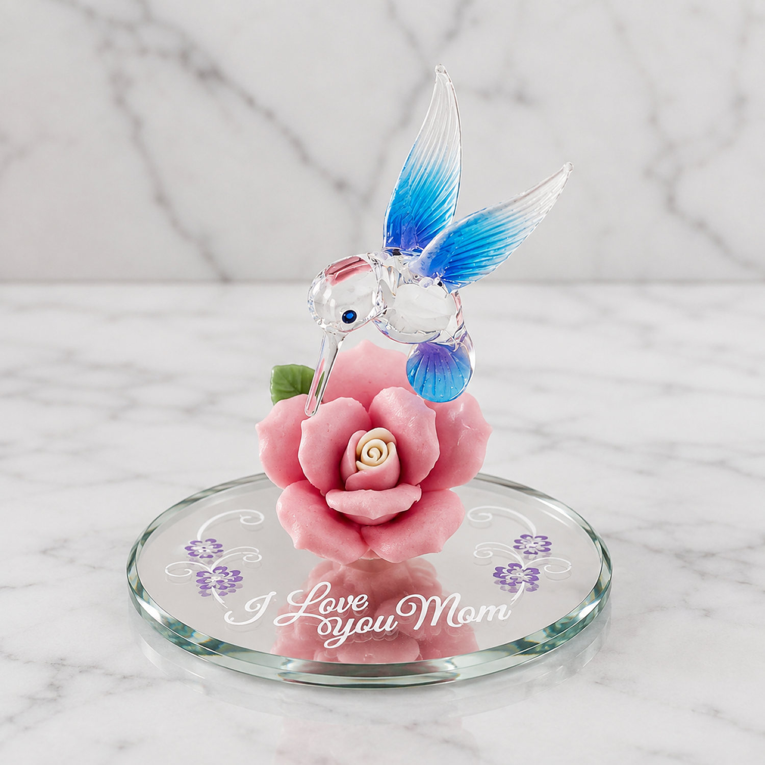 Handcrafted hummingbird figurine perched on a pink porcelain rose with crystal accents and “I Love You Mom” embossed on a beveled glass mirror.