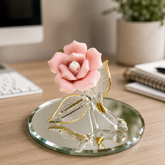 Handcrafted glass pink rose figurine with clear glass leaves, Real 22Kt Gold accents, displayed on a hand-beveled mirrored glass base.