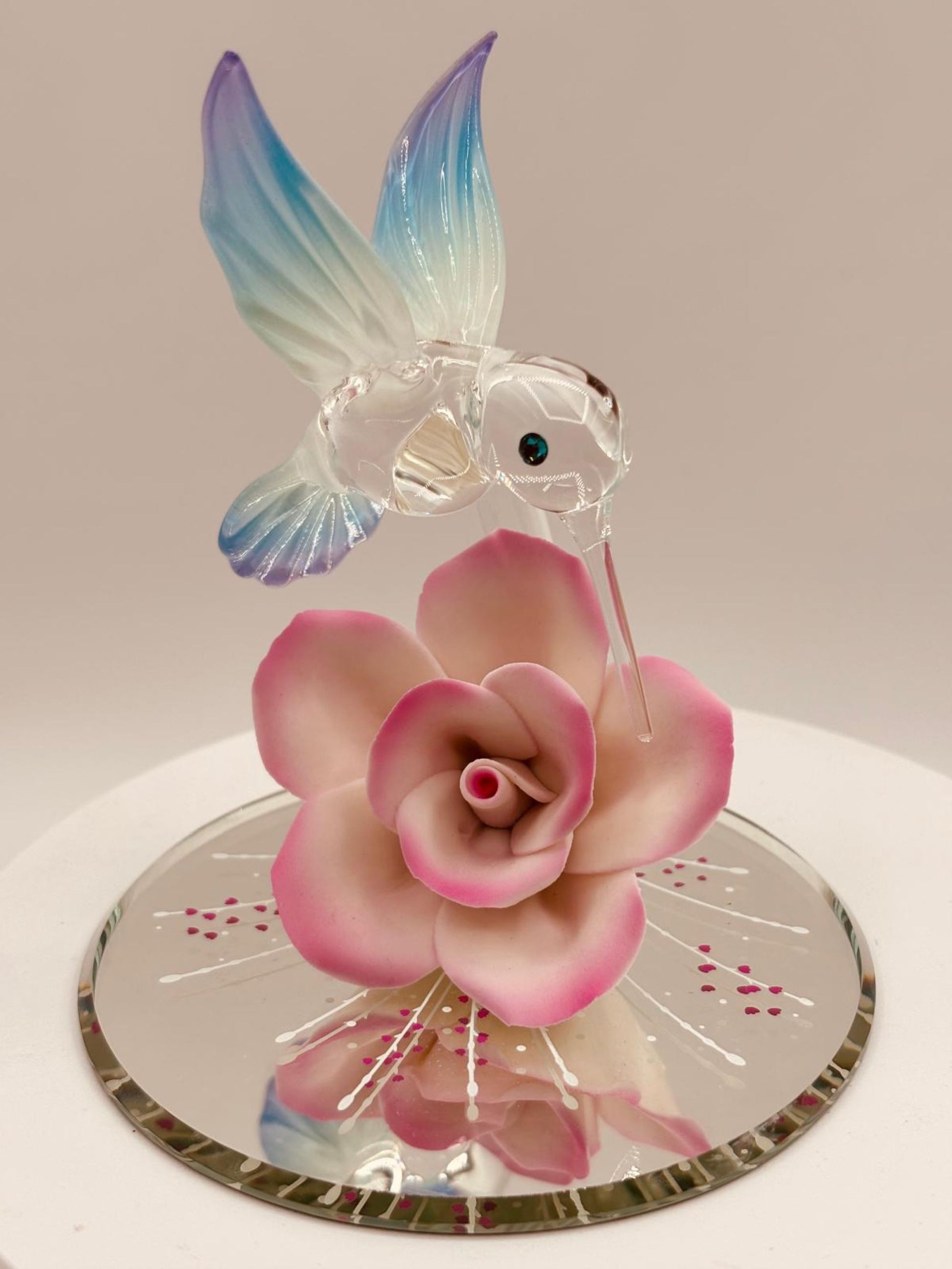 Handcrafted glass hummingbird figurine with pink porcelain rose