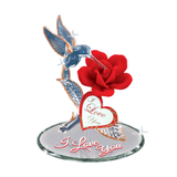 Handcrafted glass hummingbird over a red rose on a beveled mirror base with “I Love You” message