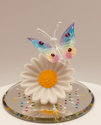 Handcrafted glass rainbow butterfly figurine on daisy with crystal accents on mirror base
