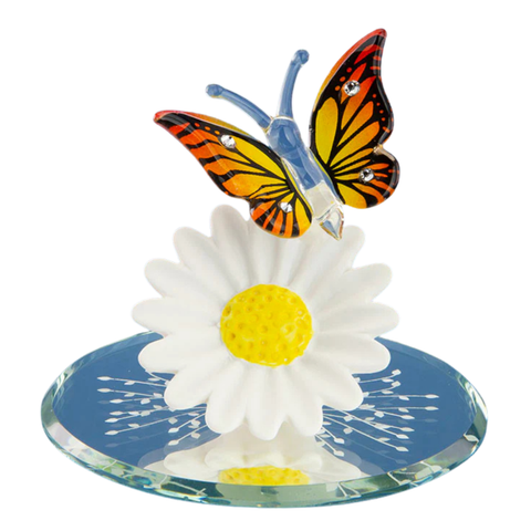 Handcrafted glass butterfly perched on a daisy with crystal accents on a beveled mirror base