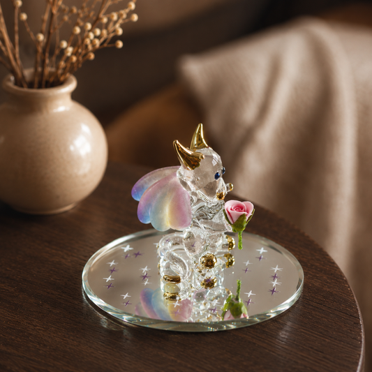 Handcrafted glass dragon figurine holding a purple rose with crystal accents on a mirrored display base.