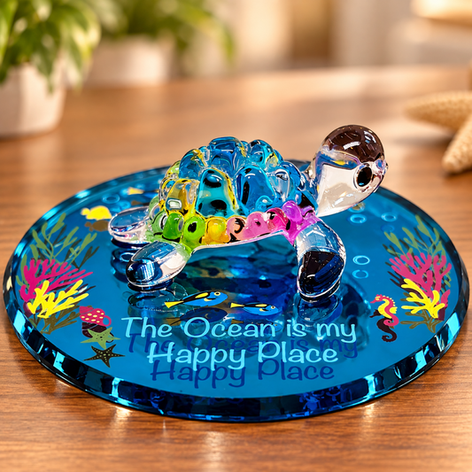 Handcrafted colorful glass sea turtle figurine with green crystal eyes on blue ocean-themed embossed glass mirror