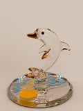 Handcrafted glass dolphin figurine riding ocean waves on a sunset beveled mirror base with crystal and gold accents