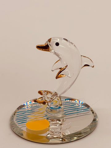 Handcrafted glass dolphin figurine riding ocean waves on a sunset beveled mirror base with crystal and gold accents
