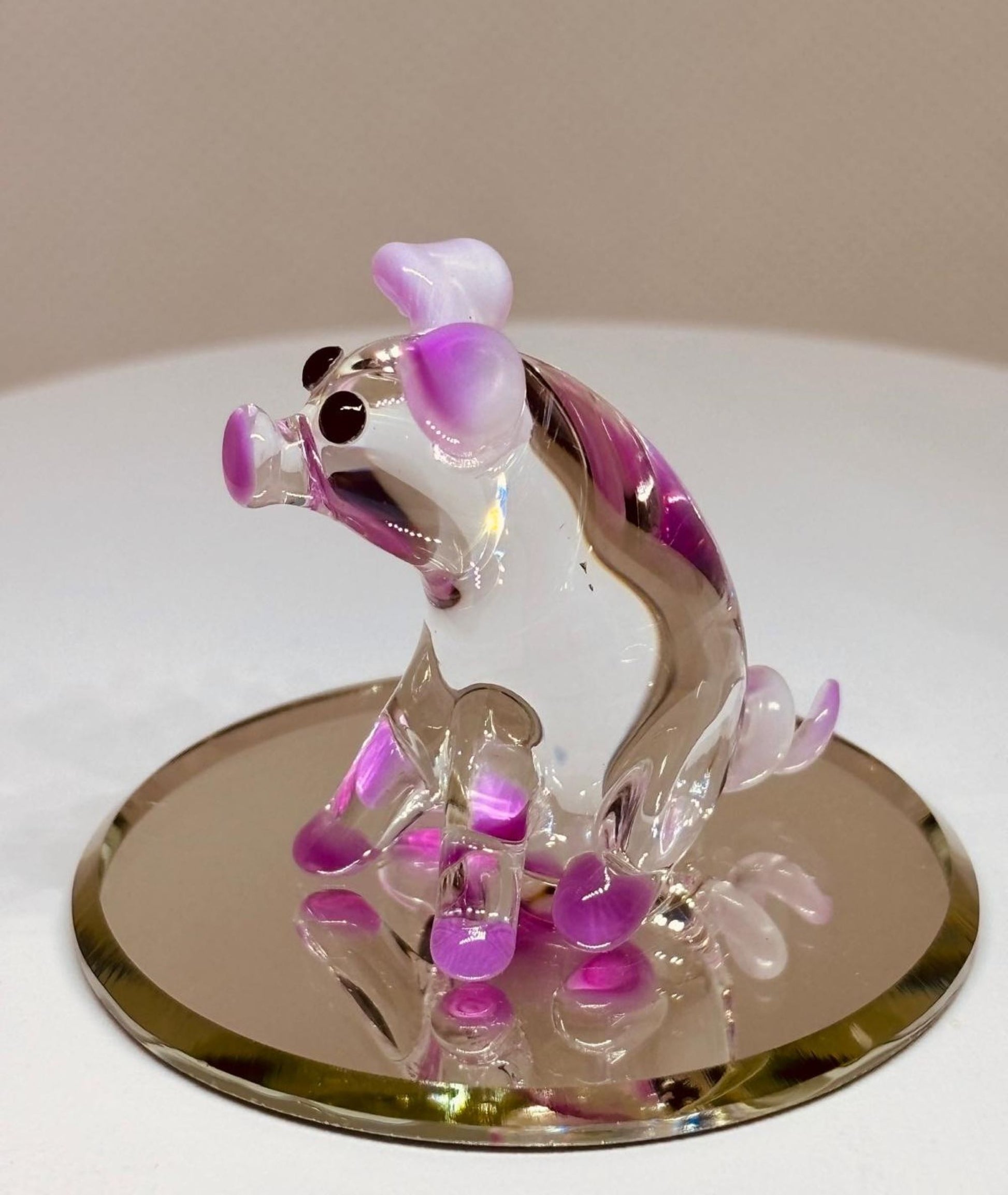 Handcrafted glass pig figurine with pink ears on mirror base