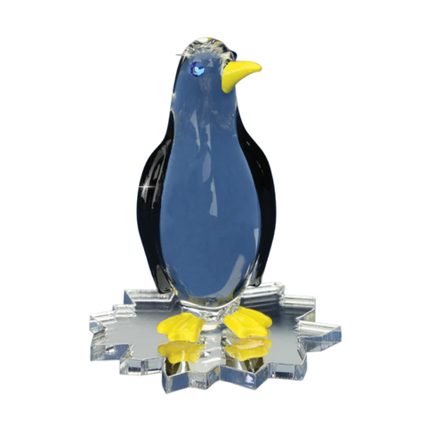 Glass penguin figurine with yellow accents on ice-shaped base