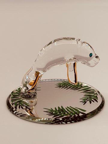 Handcrafted glass manatee figurine swimming in shallow water on a beveled mirror base with crystal and gold accents