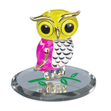 Colorful glass owl figurine with gold accents on mirror base