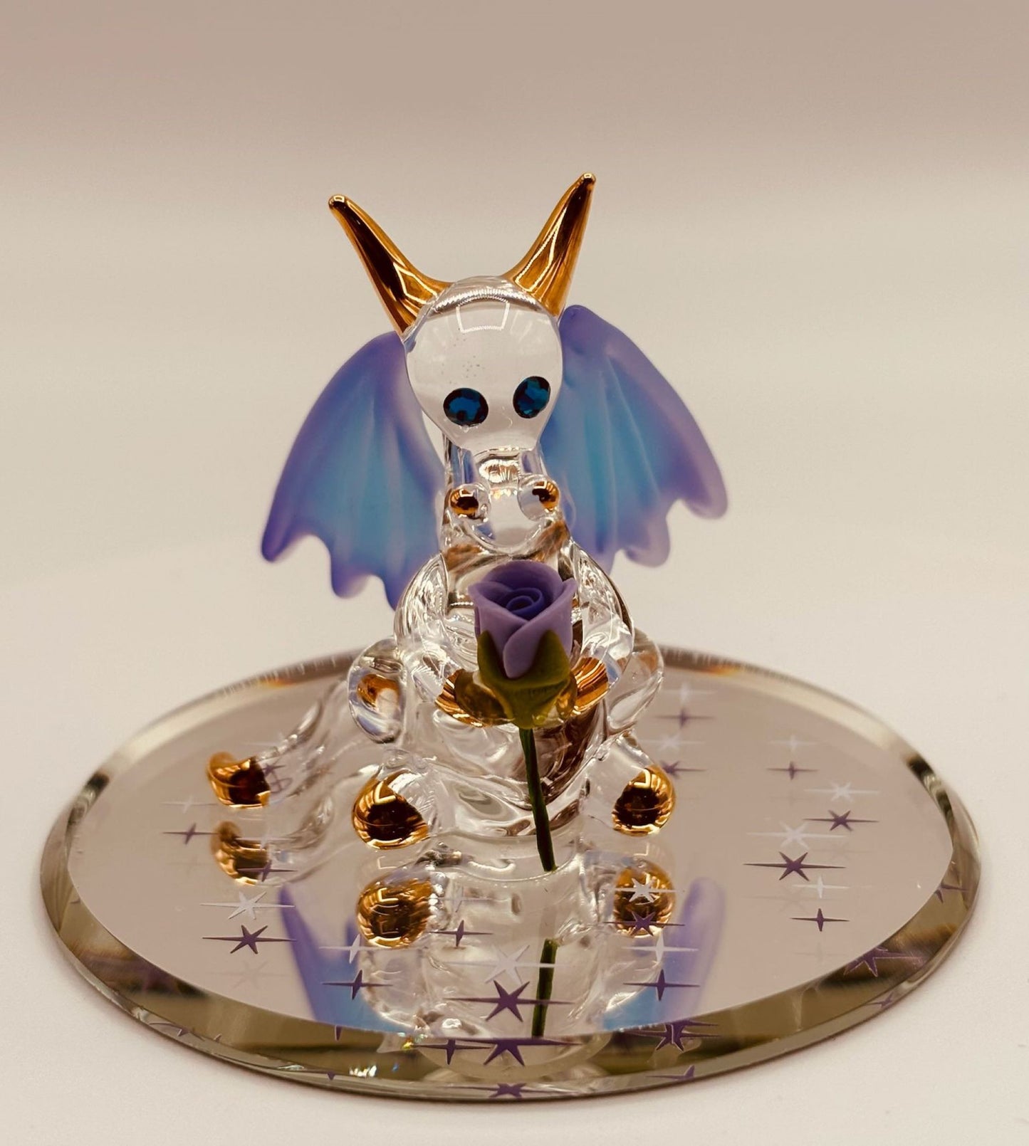 Handcrafted glass dragon holding a purple rose with crystal and 22Kt gold accents