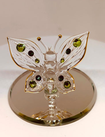 Handcrafted glass butterfly figurine with green crystals on mirror base