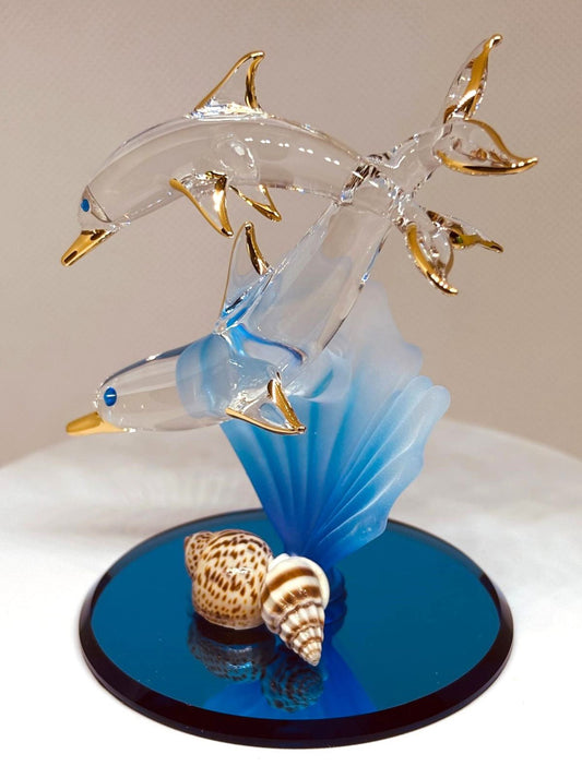 Handcrafted glass dolphin and baby figurine on blue coral with shells and gold accents