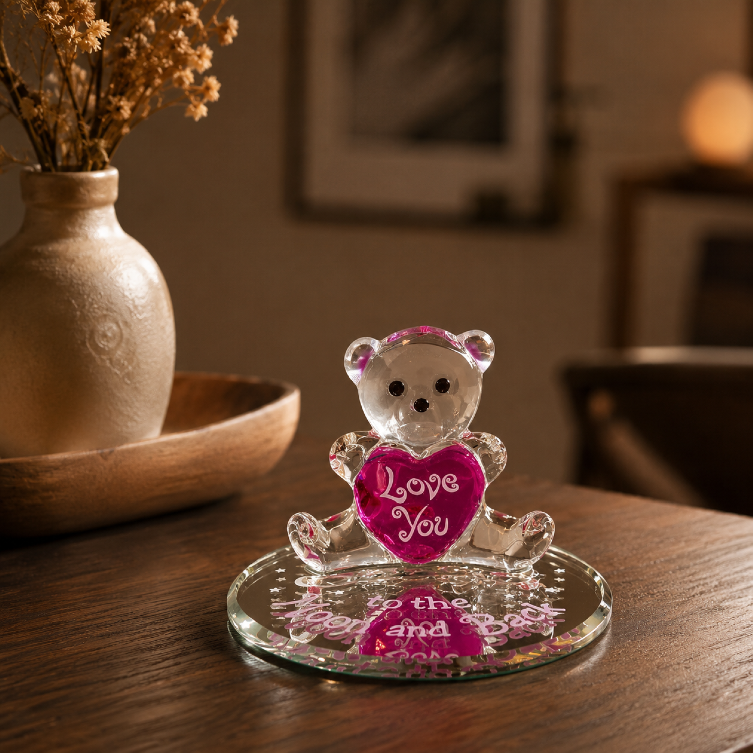 Handcrafted glass teddy bear figurine holding a pink heart on a beveled mirror base with Love You To The Moon And Back sentiment.