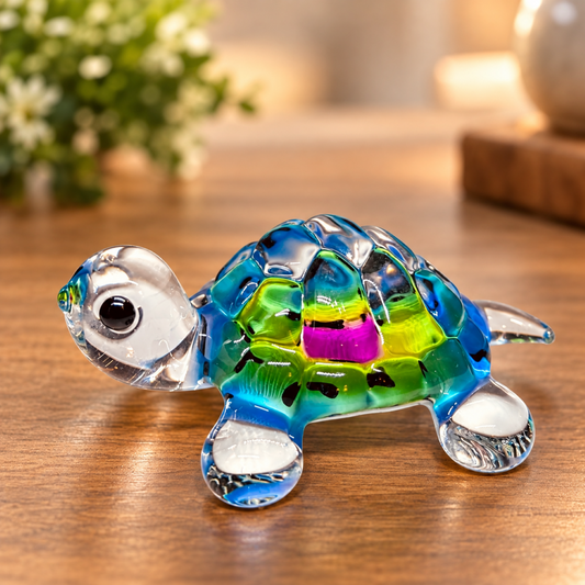 Handcrafted colorful glass tie-dye turtle figurine with green crystal eyes, blue and green shell, and clear glass flippers