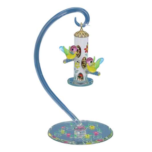 Glass bird feeder figurine with two hand painted birds hanging from curved hook on beveled mirror base