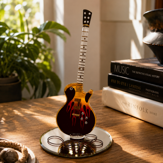 Handcrafted flame guitar glass figurine with crystal accents and gold detailing displayed on a beveled mirrored base with guitar cord design.