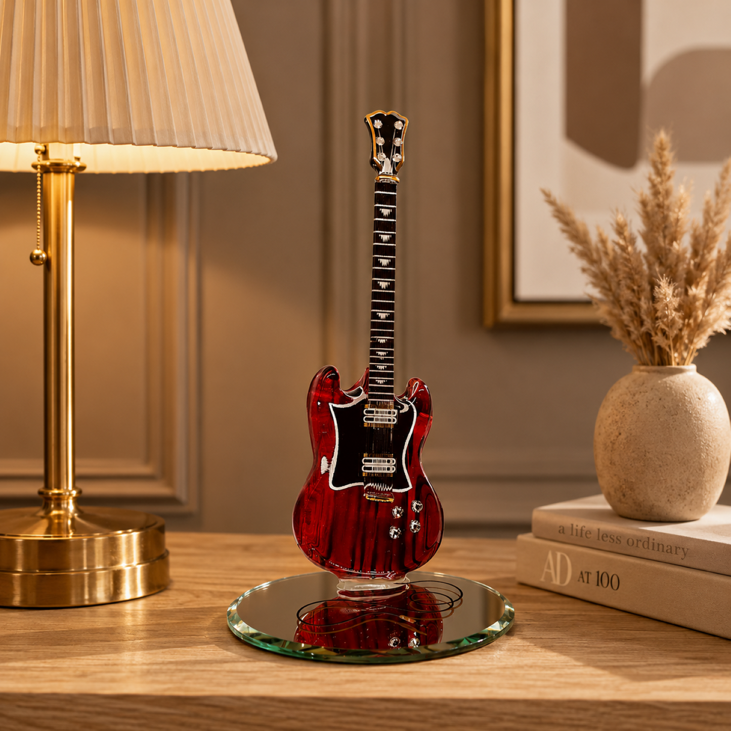 Handcrafted red glass electric guitar figurine with Genuine Crystals and Real 22Kt Gold displayed on a beveled mirror base.