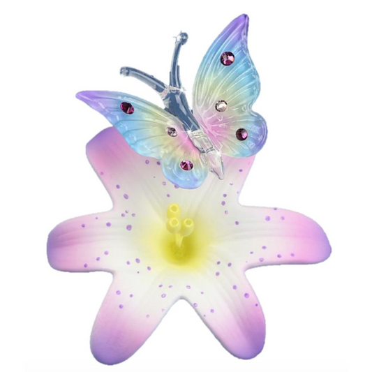 Handcrafted glass butterfly with pastel wings perched on lavender lily with crystal accents