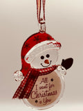 Handcrafted glass snowman ornament hanging from red ribbon with “All I Want for Christmas Is You” message and crystal accents