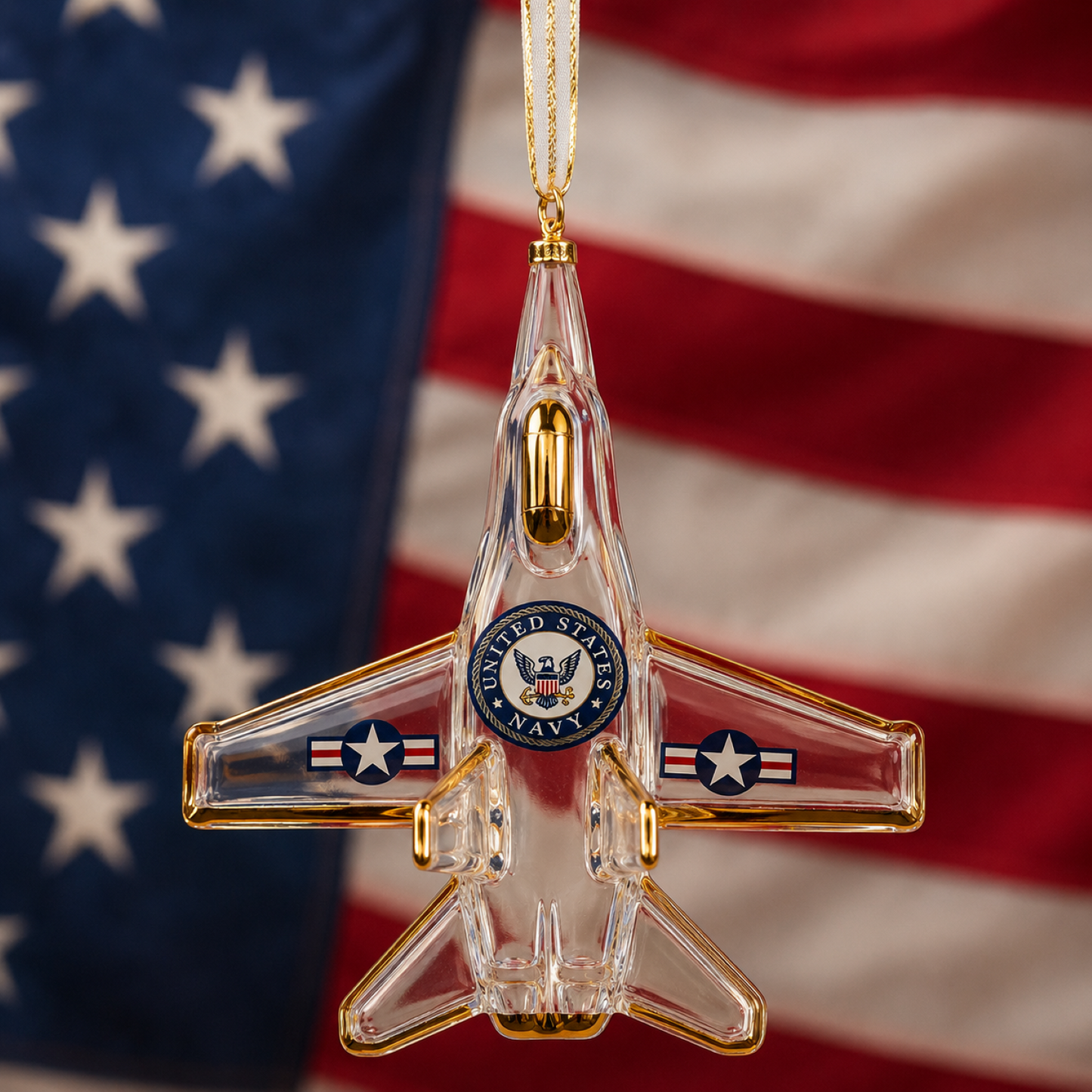 Handcrafted U.S. Navy F-18 Jet glass ornament with gold accents, classic Navy emblem, and gold hanging ribbon for patriotic Christmas tree décor.