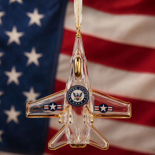 Handcrafted U.S. Navy F-18 Jet glass ornament with gold accents, classic Navy emblem, and gold hanging ribbon for patriotic Christmas tree décor.