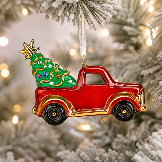 Handcrafted red glass Christmas truck ornament carrying a green Christmas tree with crystal and 22Kt gold accents