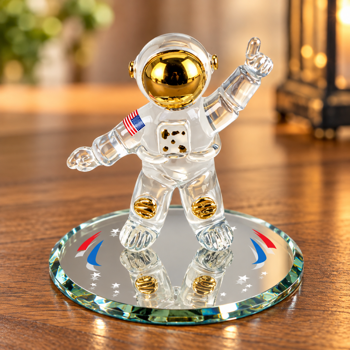 Handcrafted glass astronaut figurine with a gold-tone helmet and U.S. flag detail on a beveled glass mirror decorated with stars