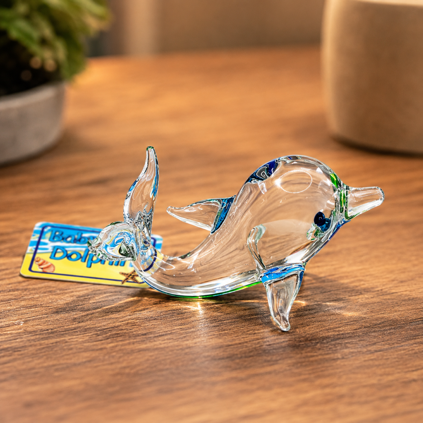 Handcrafted clear glass Baby Dolphin figurine with blue accents and colorful Baby Dolphin tag